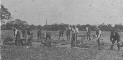 Men working in field.